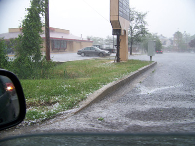 Rain with hail -- the white stuff on the edge of road.
