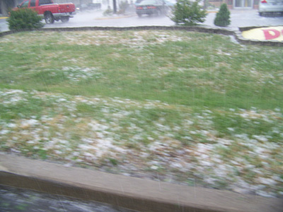 Hail stones on the side of the road.